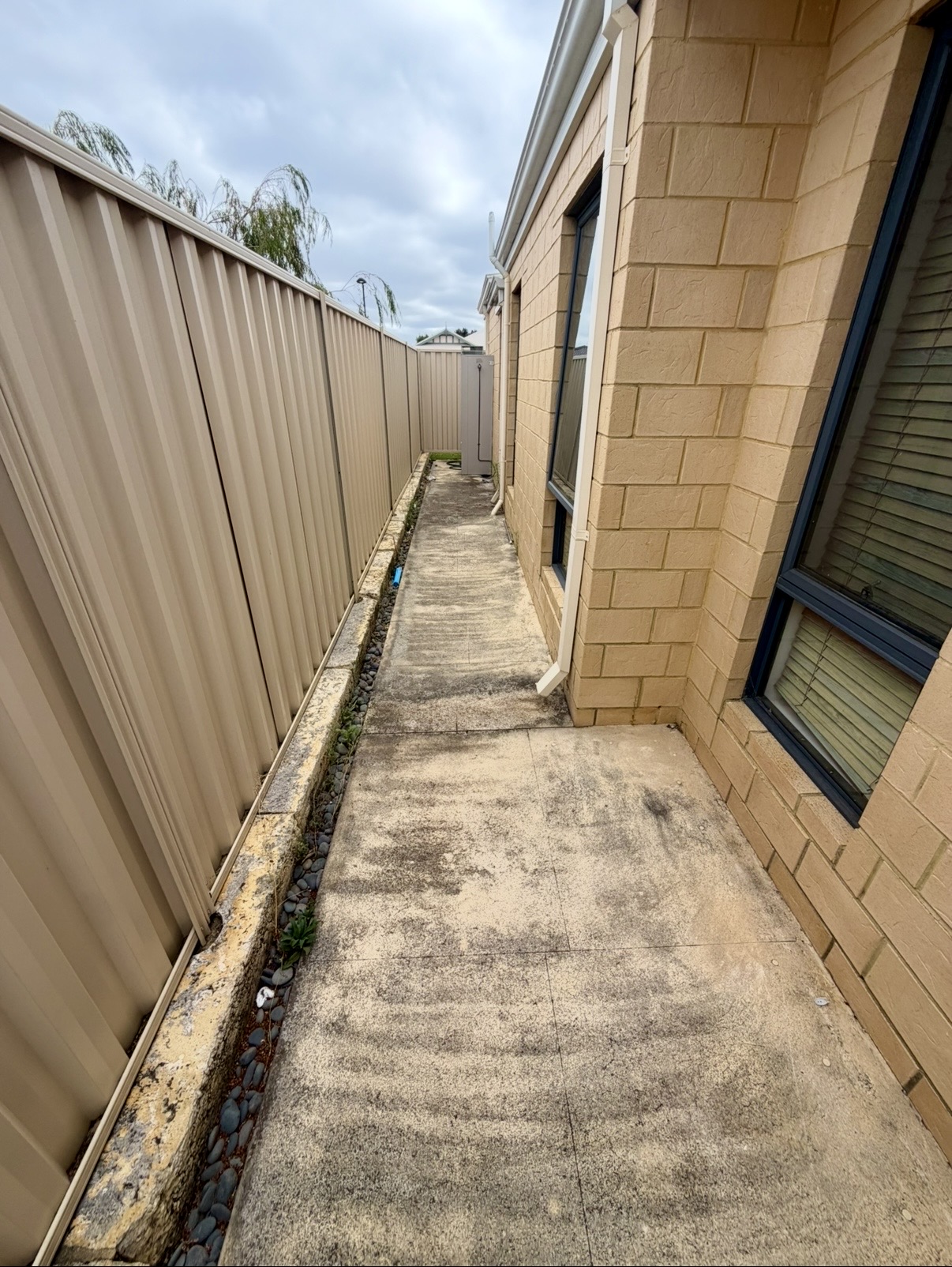 Liquid limestone Concrete side passage before — pressure cleaning Burns Beach Perth WA