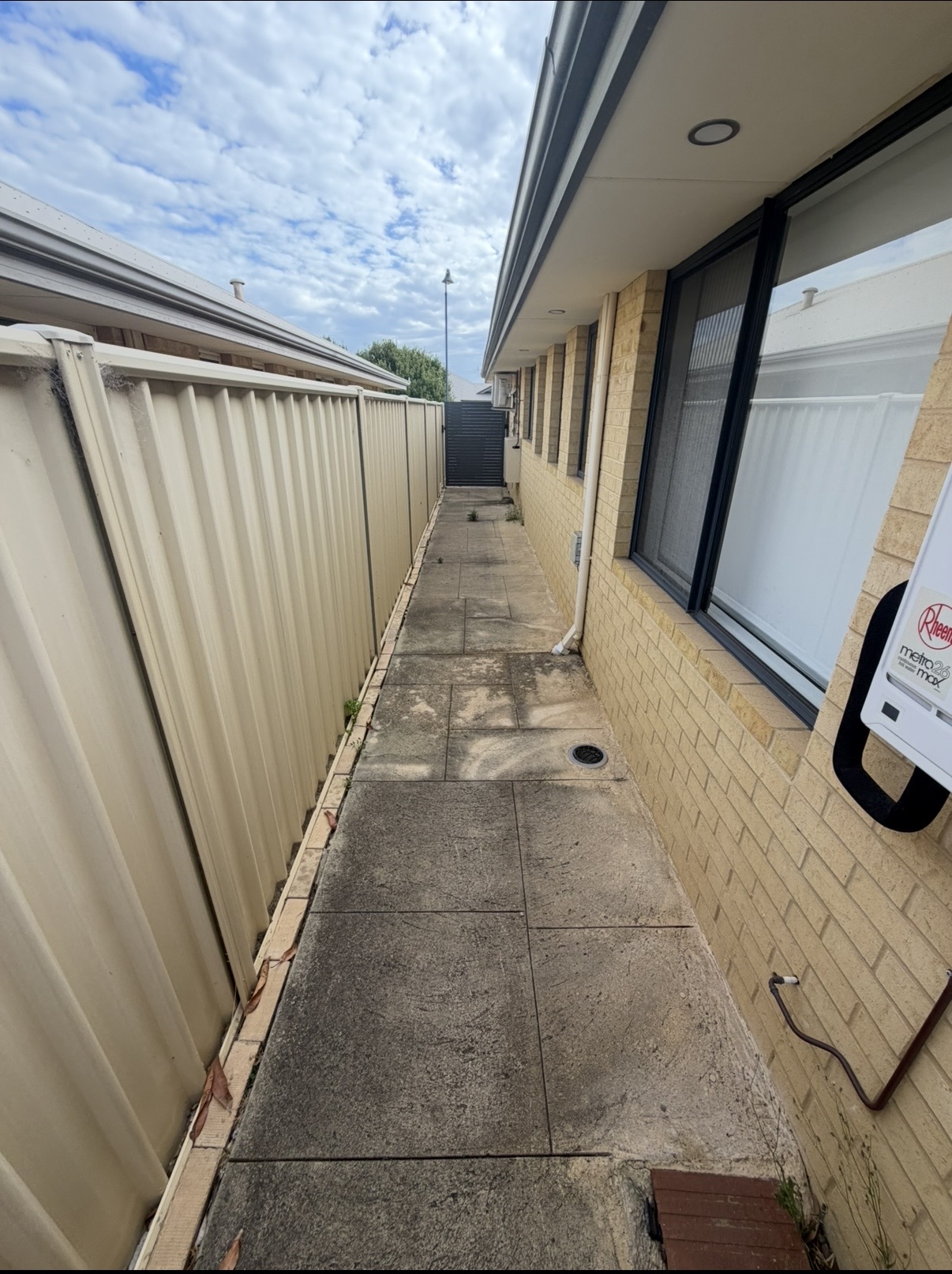 Liquid limestone Long concrete side passage before — pressure cleaning Mindarie Perth WA